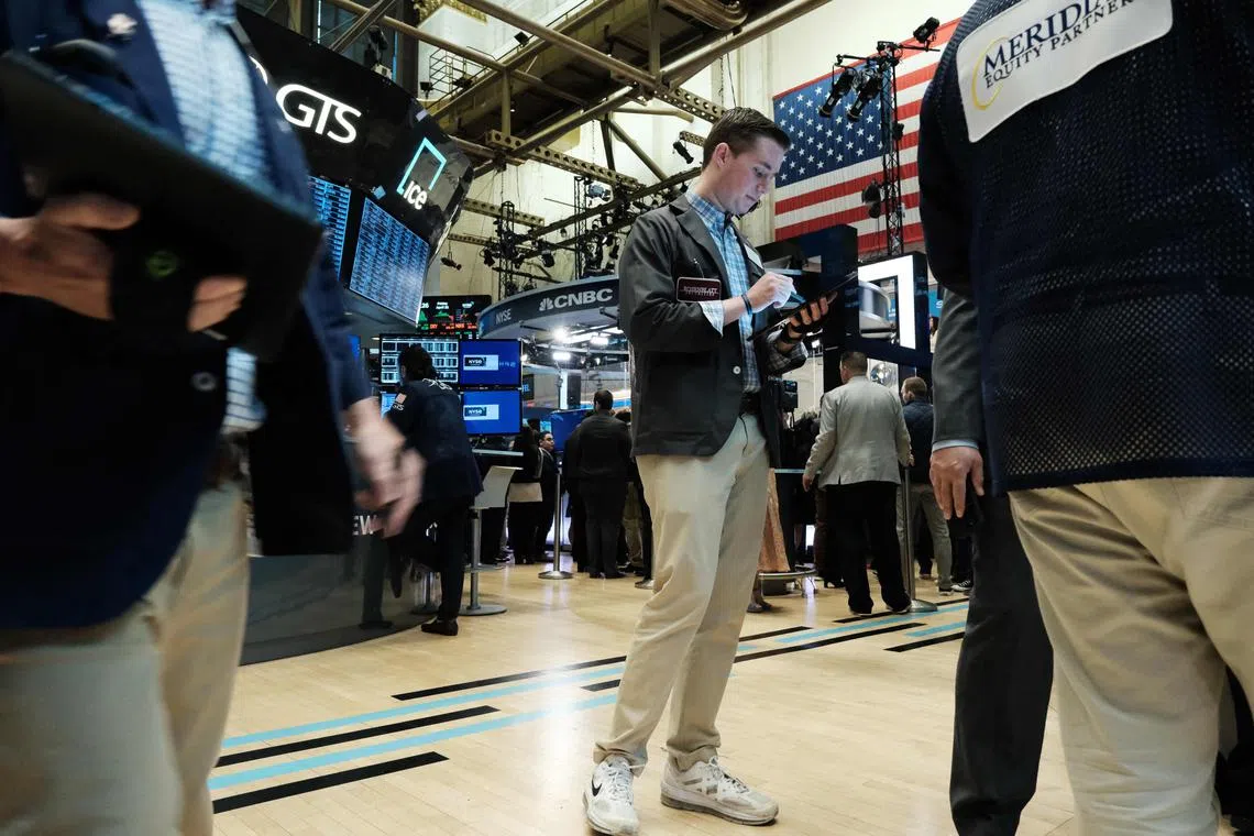 Traders work on the floor of the New York Stock Exchange, in New York City.
