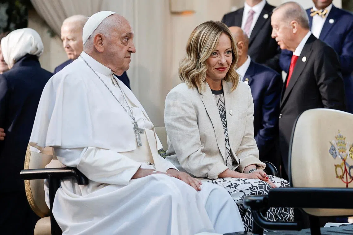 FILE PHOTO: Pope Francis sits with Italian Prime Minister Giorgia Meloni, as they attend a family photo session, on the second day of the G7 summit at the Borgo Egnazia resort, in Savelletri, Italy, June 14, 2024. REUTERS/Louisa Gouliamaki/File Photo