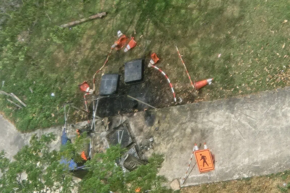 SCDF put out the fire from a manhole on a pedestrian walkway.