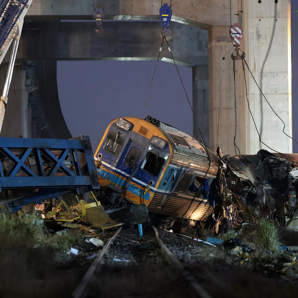 Wreckage at the site where a train was derailed when a construction crane collapsed and fell onto its carriages, causing several casualties, in Sikhio district, Nakhon Ratchasima province, Thailand, January 14, 2026. REUTERS/Chalinee Thirasupa