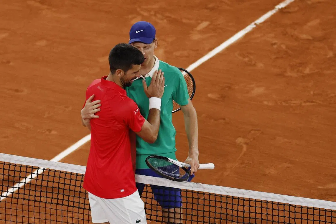 Tennis - French Open - Roland Garros, Paris, France - June 6, 2025  Italy's Jannik Sinner hugs Serbia's Novak Djokovic after winning his semi final match REUTERS/Stephanie Lecocq