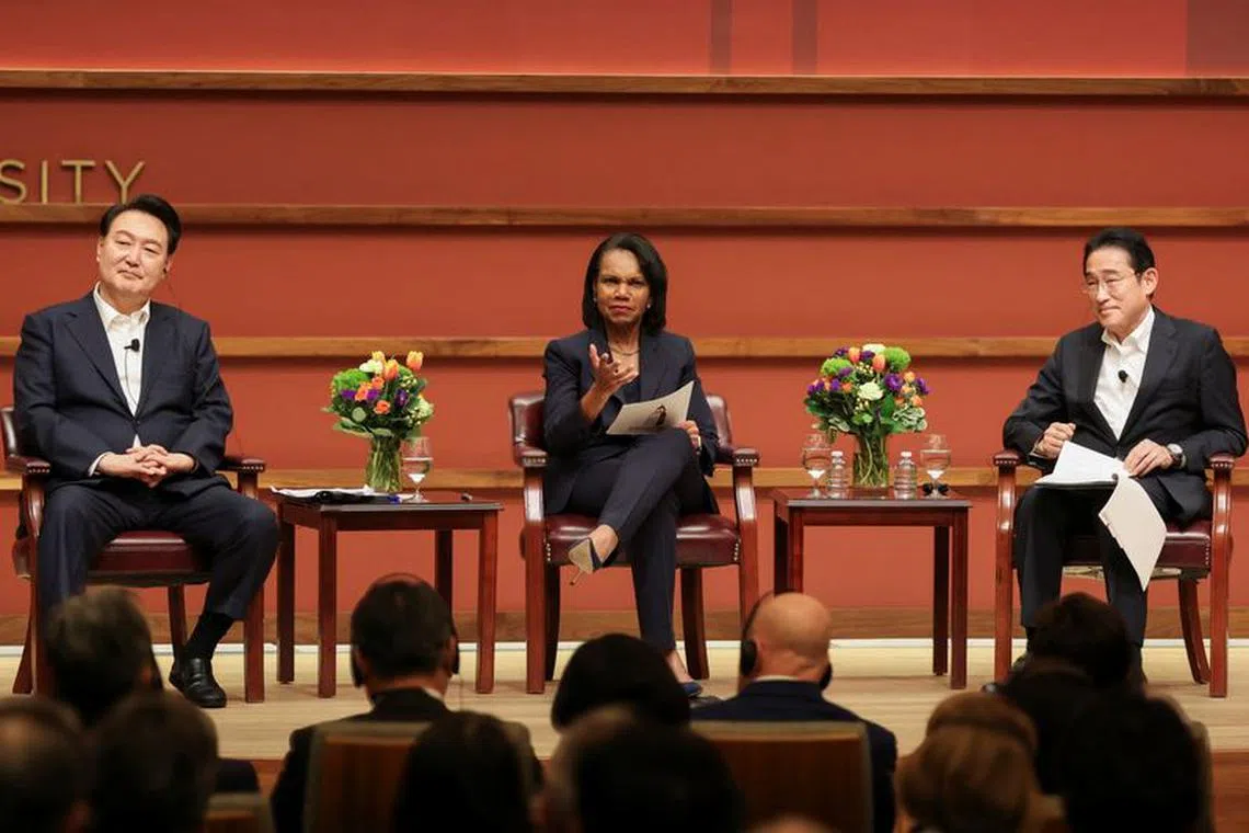 Japan's Prime Minister Fumio Kishida and South Korea's President Yoon Suk Yeol along with moderator and former U.S. Secretary of State Condoleezza Rice attend a summit discussion, on the sidelines of the Asia-Pacific Economic Cooperation (APEC) summit, at the Stanford, California, U.S., November 17, 2023.  REUTERS/Brittany Hosea-Small