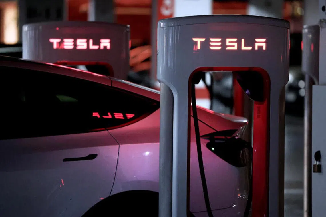 FILE PHOTO: A Tesla electric vehicle is charged at a Tesla Supercharger battery charging station in Barakaldo, Spain, March 29, 2025. REUTERS/Vincent West/File Photo