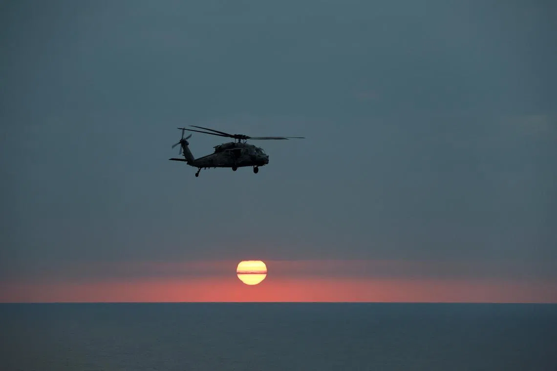 FILE PHOTO: An MH-60R Seahawk of The Swamp Foxes HSM-74 approaches the flight-deck of the USS Dwight D. Eisenhower (CVN 69) aircraft carrier during evening flight-operation in Southern Red Sea, Middle East, February 12, 2024. REUTERS/Hamad I Mohammed/File Photo