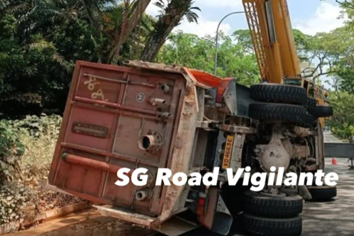 In a video posted on the SG Road Vigilante Facebook page, a crane truck is seen lifting the lorry back into an upright position.
