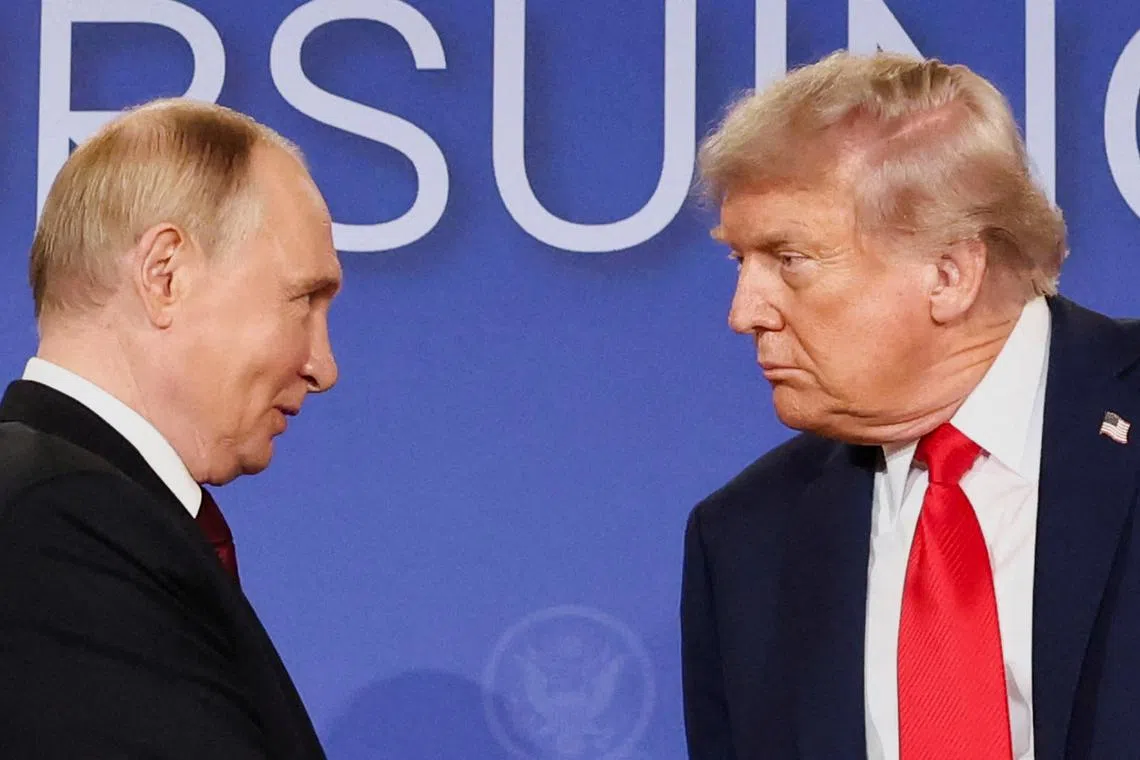 FILE PHOTO: U.S. President Donald Trump and Russian President Vladimir Putin look at each other during a press conference following their meeting to negotiate an end to the war in Ukraine, at Joint Base Elmendorf-Richardson, in Anchorage, Alaska, U.S., August 15, 2025. REUTERS/Kevin Lamarque/File Photo