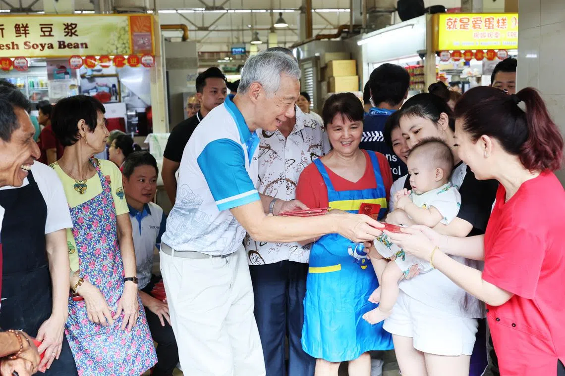 PM Lee Hsien Loong handing out hongbao and chatting with residents in Teck Ghee on Jan 28.