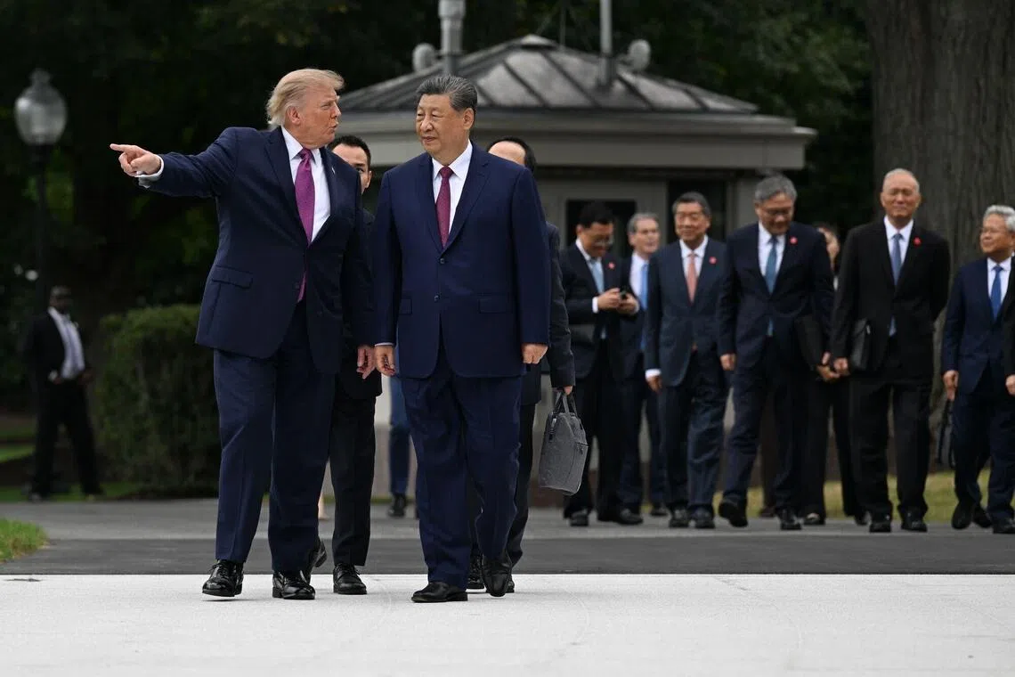 US President Donald Trump and Chinese President Xi Jinping during a tour to see Marine One on the new helipad on the South Lawn of the White House on Sept 24.