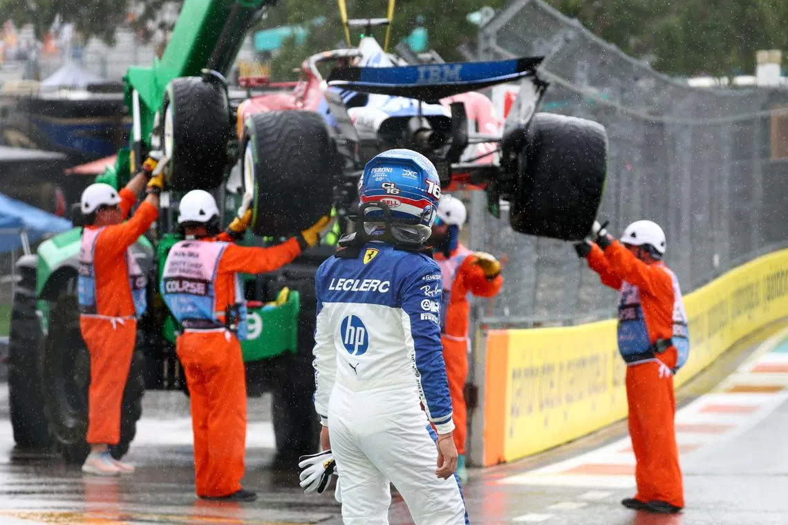 Marshals removing Charles Leclerc's car from the circuit after he aquaplaned in heavy rain during warm-up laps for the Miami grand prix weekend sprint race.