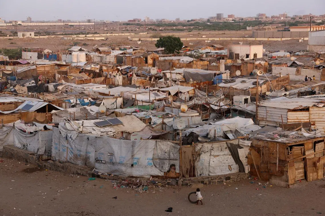A girl plays with a tire next to a displaced persons camp in Aden, Yemen, October 19, 2024. REUTERS/Amr Alfiky
