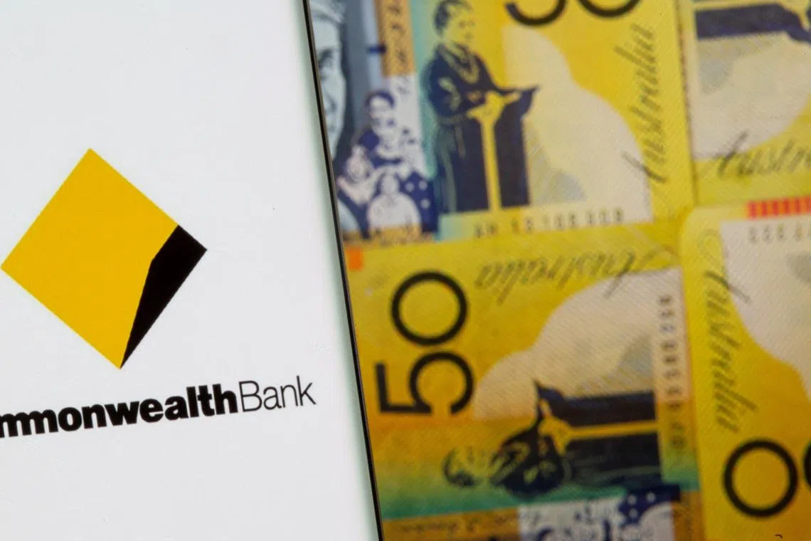 FILE PHOTO: Commonwealth Bank logo is seen on a smartphone in front of displayed Australian dollar banknotes in this illustration taken, November 8, 2021. REUTERS/Dado Ruvic/Illustration/File Photo