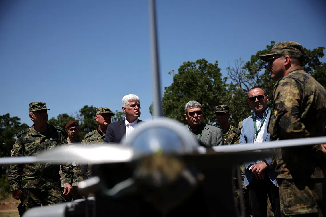 Bulgarian defence minister Dimitar Stoyanov talks to soldiers near a drone during \"Strike Back 26\" military drill, involving troops and vehicles from Bulgaria, the U.S., Italy, Turkey, and Romania, in Koren, Bulgaria, June 11, 2026. REUTERS/Stoyan Nenov