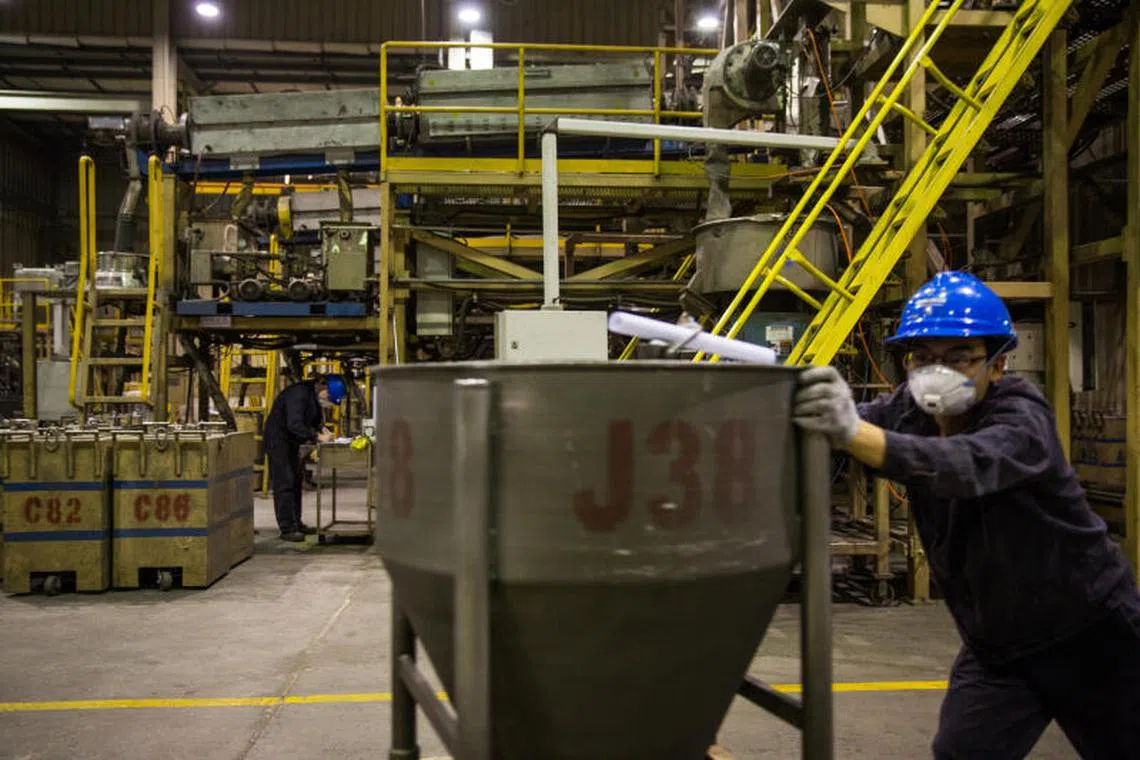 FILE — Workers at the Magnequench Company make magnetic powders and products using rare earth metals in Tianjin, China on Oct. 16, 2023. The United States allowed its rare earth metals industry to move to China and could now face severe economic disruption as China limits crucial supplies. (Sim Chi Yin/The New York Times)