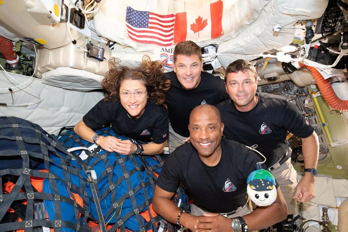 The NASA Artemis II crew, Mission Specialist Christina Koch, Mission Specialist Jeremy Hansen, Commander Reid Wiseman, and Pilot Victor Glover, pose for a group photo inside the Orion spacecraft on their way home following a flyby of the far side of the Moon on April 6, 2026. NASA/Handout via REUTERS
