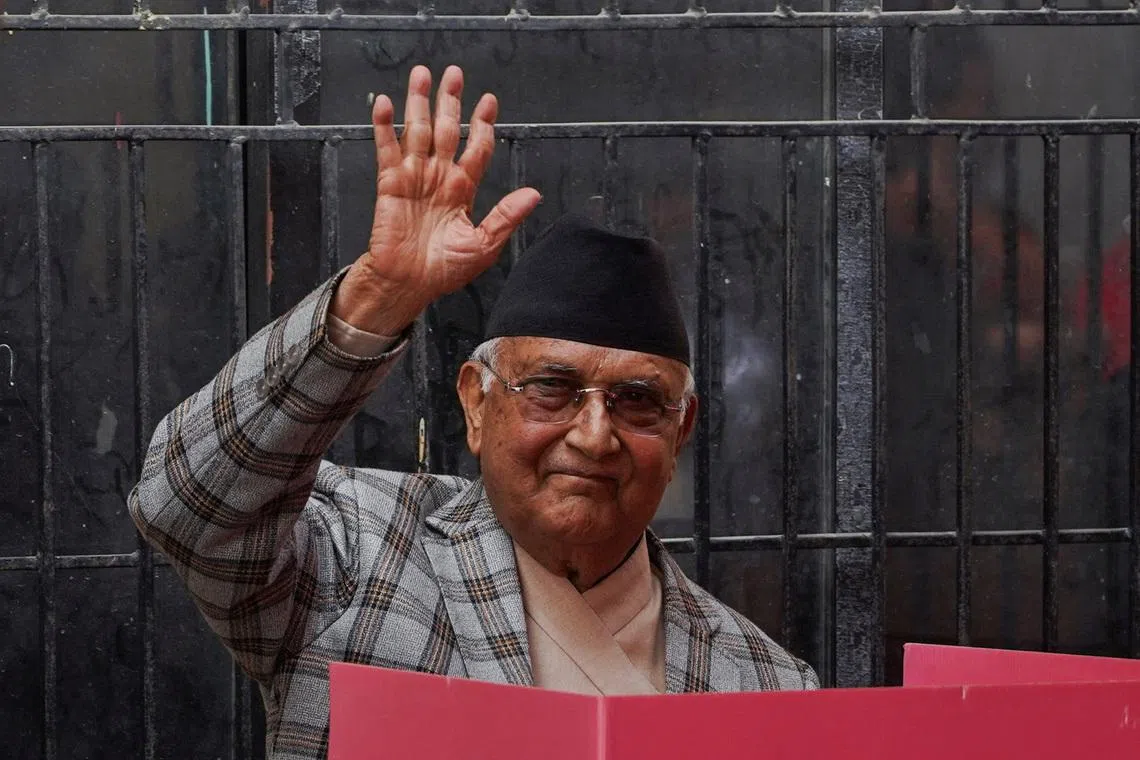 Former Prime Minister of Nepal and Chairman of Communist Party of Nepal (Unified Marxist- Leninist) K.P Sharma Oli, who was forced to resign after the deadly youth-led protests against corruption early September last year, waves ahead of voting during the general election in Bhaktapur, Nepal, March 5, 2026. REUTERS/Sabrina Dangol