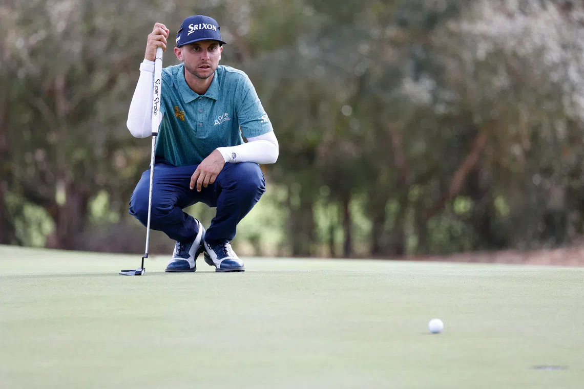FILE PHOTO: Jan 9, 2026; Lecanto, Florida, United States; John Catlin lines up his putt on the eighteeth green during the second round of the LIV Golf Black Diamond Ranch golf tournament at Black Diamond Ranch. Mandatory Credit: Jeff Swinger-Imagn Images/File Photo