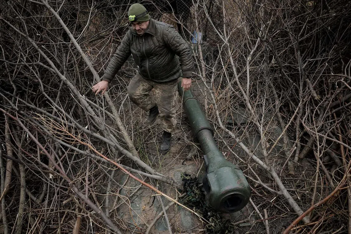 A serviceman of 24th Mechanised brigade preparing a 2S1 Gvozdika self-propelled howitzer, amid Russia's attack on Ukraine, near the town of Chasiv Yar in Donetsk region, Ukraine, Nov 13, 2024. 