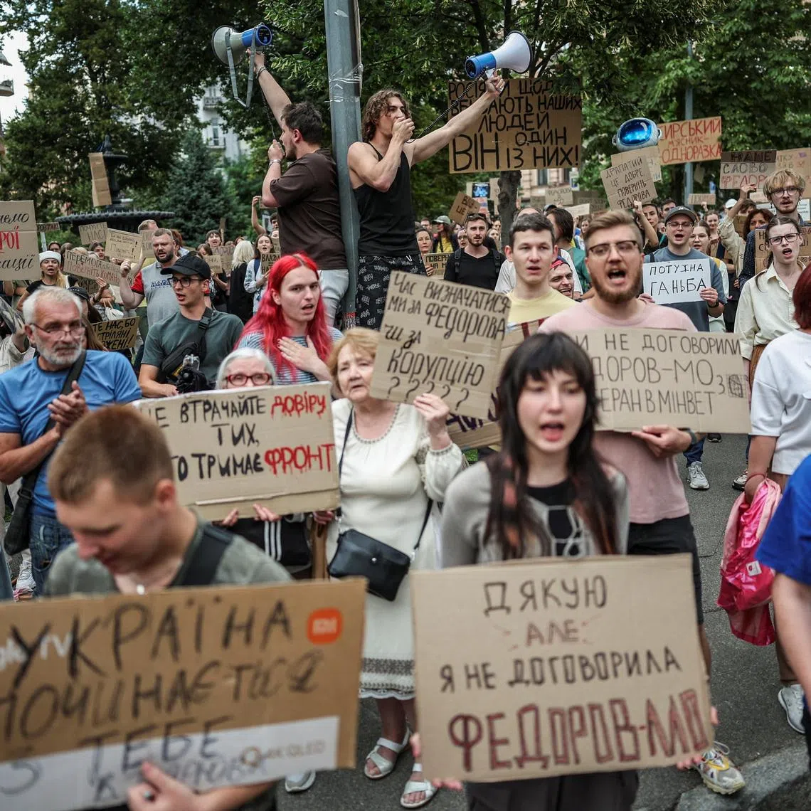 Participants hold signs and shout slogans during a rally to protest against Ukrainian President Volodymyr Zelenskiy's decision to replace Mykhailo Fedorov as Defence Minister, amid Russia's attack on Ukraine, in Kyiv, Ukraine, July 24, 2026. REUTERS/Alina Smutko