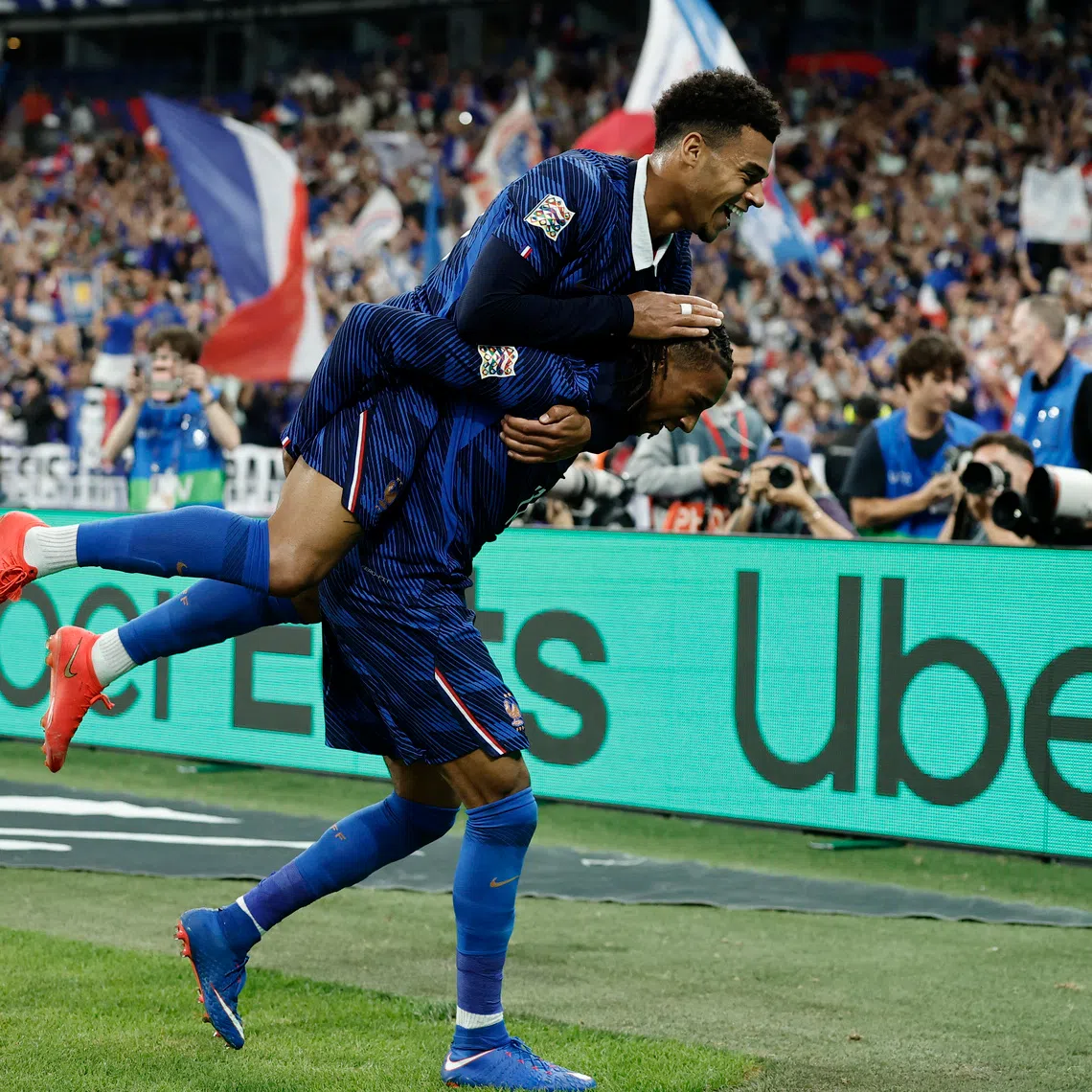 France’s Michael Olise celebrates scoring their third goal against the Belgians with Desire Doue in the Nations League Group A1 match on Oct 5.