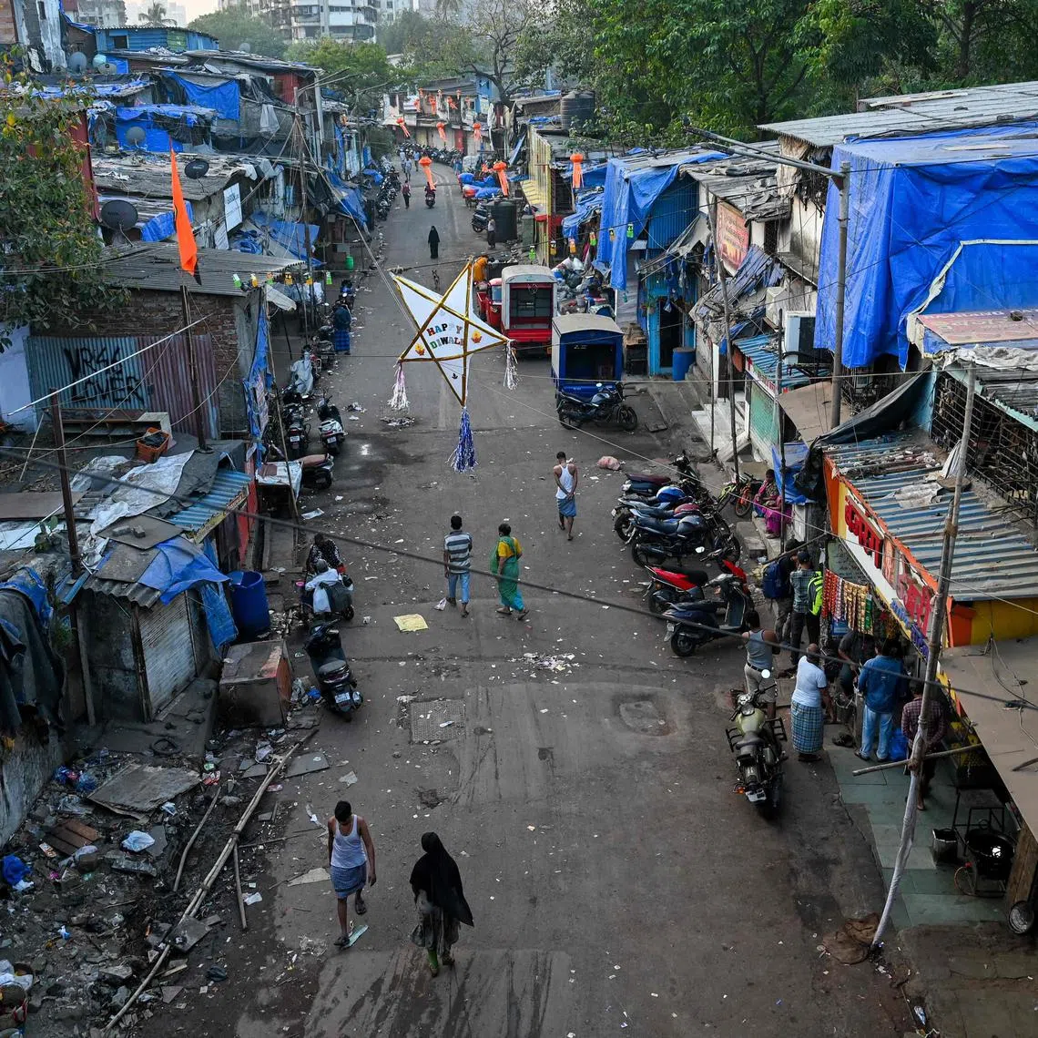 Residents walk through a street along the Dharavi slums, on Nov 2, 2022.