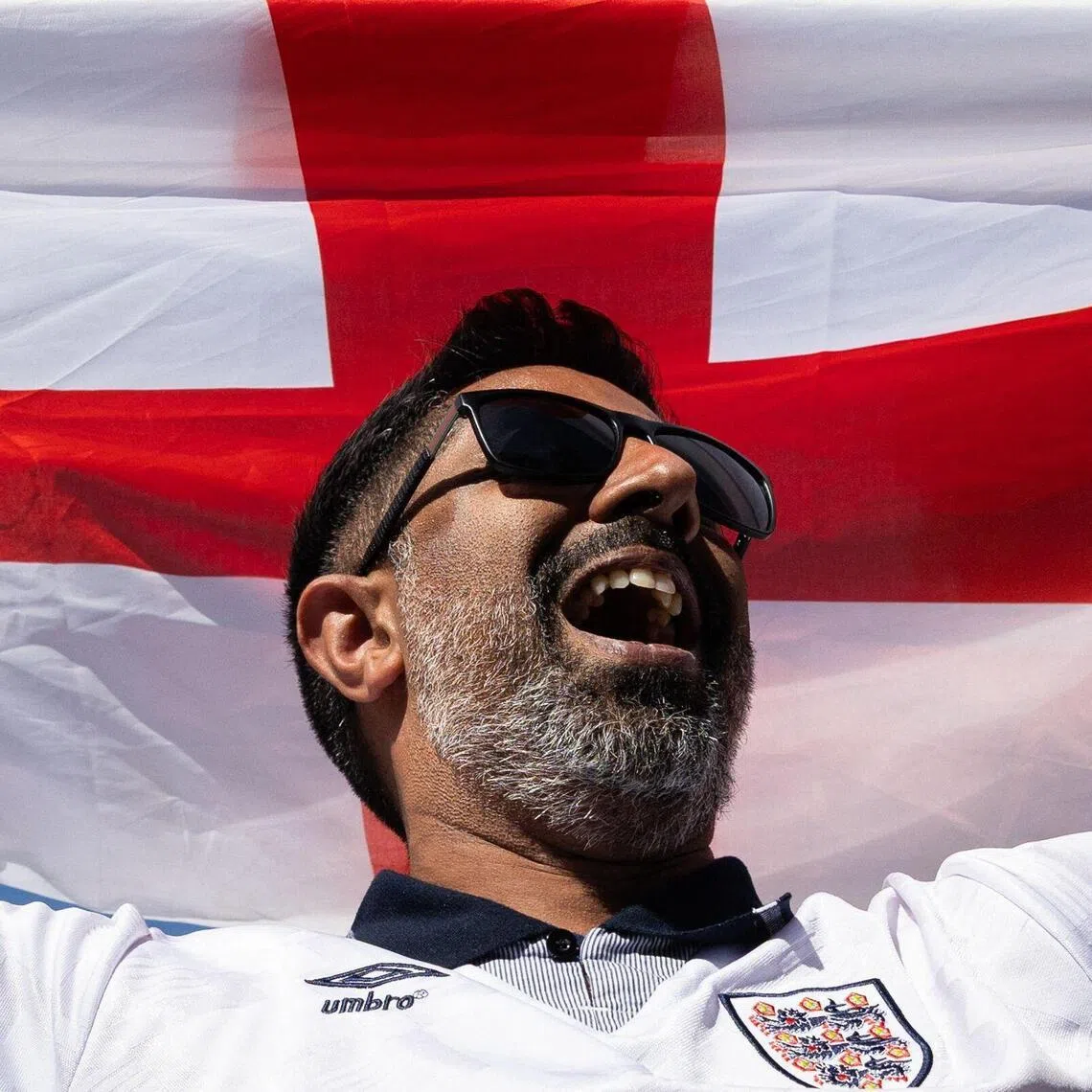 An England's fan cheers during a viewing party for the World Cup third-place football match between France and England in Burbank, California, on July 18, 2026. (Photo by Blake Fagan / AFP)