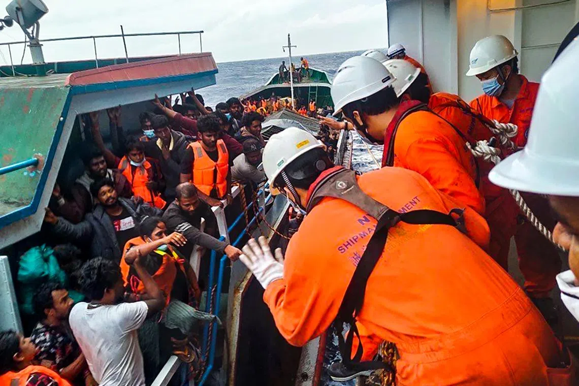 Passengers of the sinking ship being rescued by crew members of a Japan-flagged vessel off the coast of Vietnam on Nov 8.