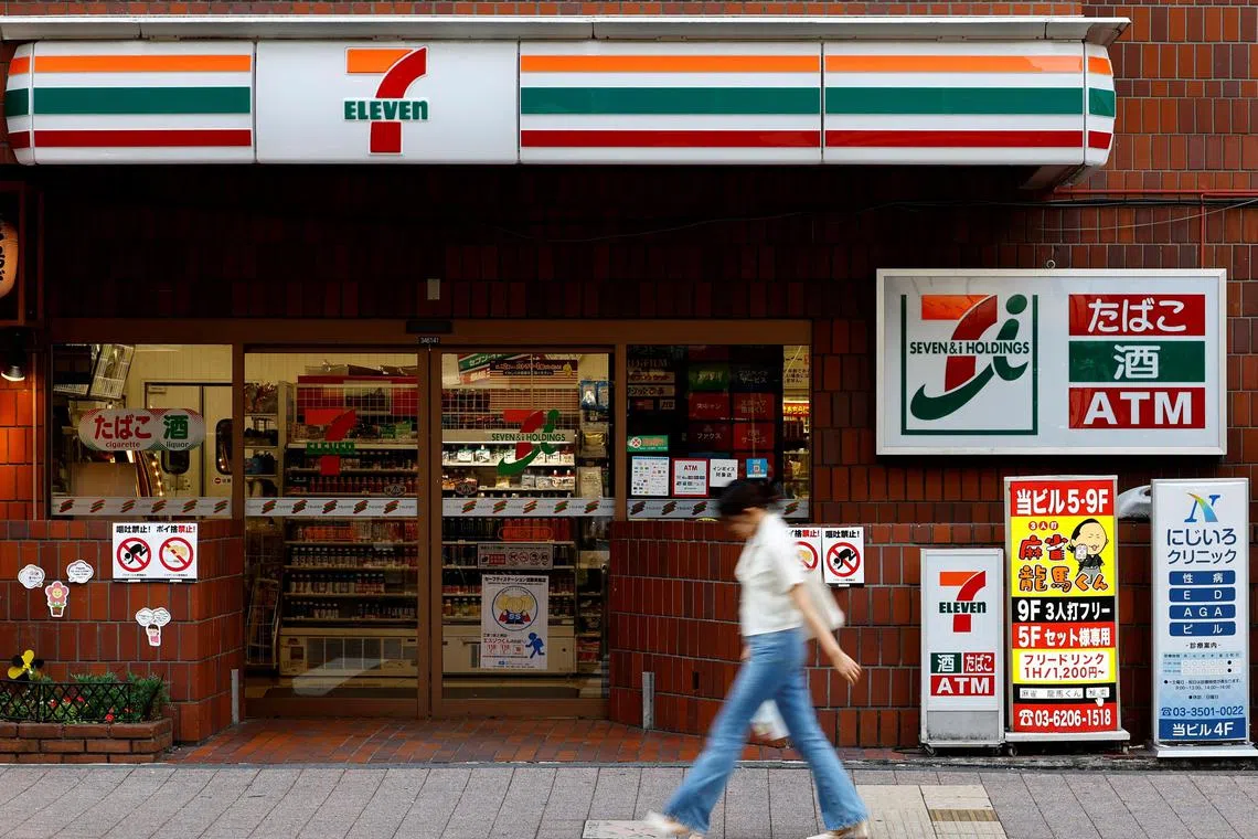 A pedestrian walks past Japan's Seven & I’s 7-Eleven convenience store in Tokyo, Japan August 19,  2024. REUTERS/Kim Kyung-Hoon