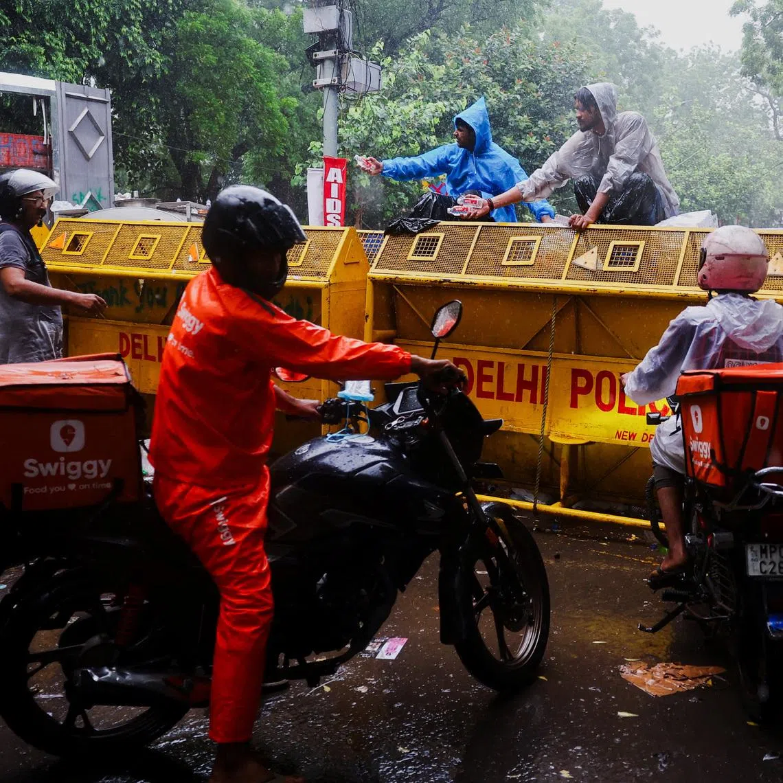 Food delivery bikes arrive at a barricade near the India's Cockroach Janata Party (CJP) protest site to deliver foods, two days after thousands of protesters marched towards parliament demanding the resignation of Education Minister Dharmendra Pradhan over examination paper leaks, at Jantar Mantar in New Delhi, India, July 22, 2026. REUTERS/Anushree Fadnavis