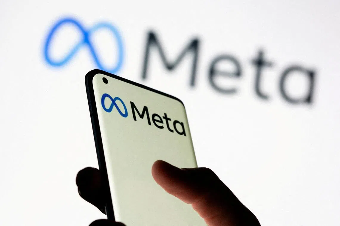 FILE PHOTO: Woman holds smartphone with Meta logo in front of a displayed Facebook's new rebrand logo Meta in this illustration picture taken October 28, 2021. REUTERS/Dado Ruvic/Illustration/File Photo