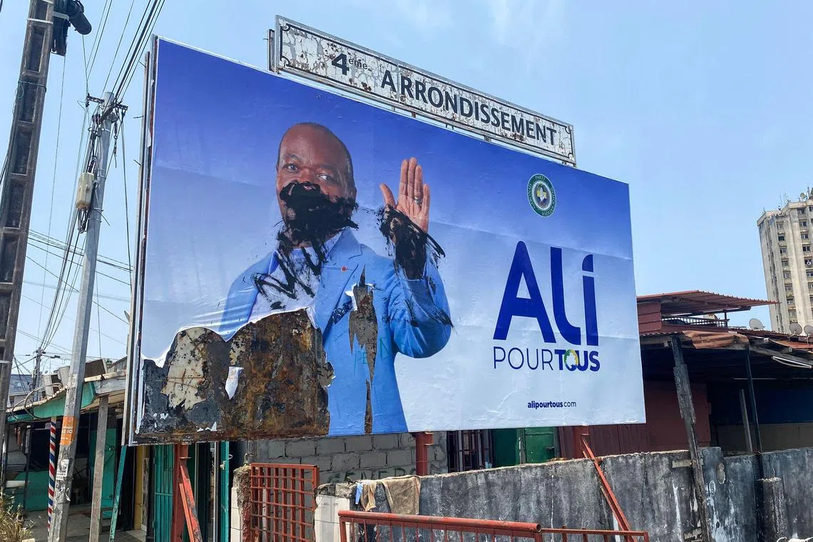 A defaced campaign billboard of ousted Gabon President Ali Bongo Ondimba, in Libreville.