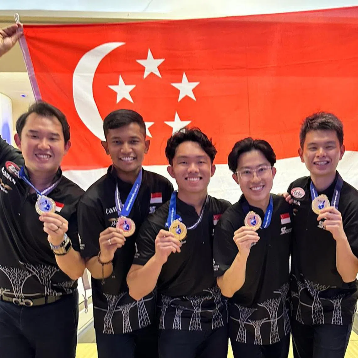 (From left) Singapore's Jaris Goh, Nu’man Syahmi, Mike Ong, Darren Ong and Joel Tan celebrating the country's first men's team gold at the Asian Tenpin Bowling Championships since 1982.