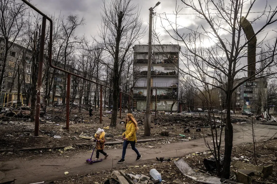 A mother and daughter walk through their destroyed neighbourhood in Myrnohrad, a town in the Donetsk region of southeastern Ukraine.
