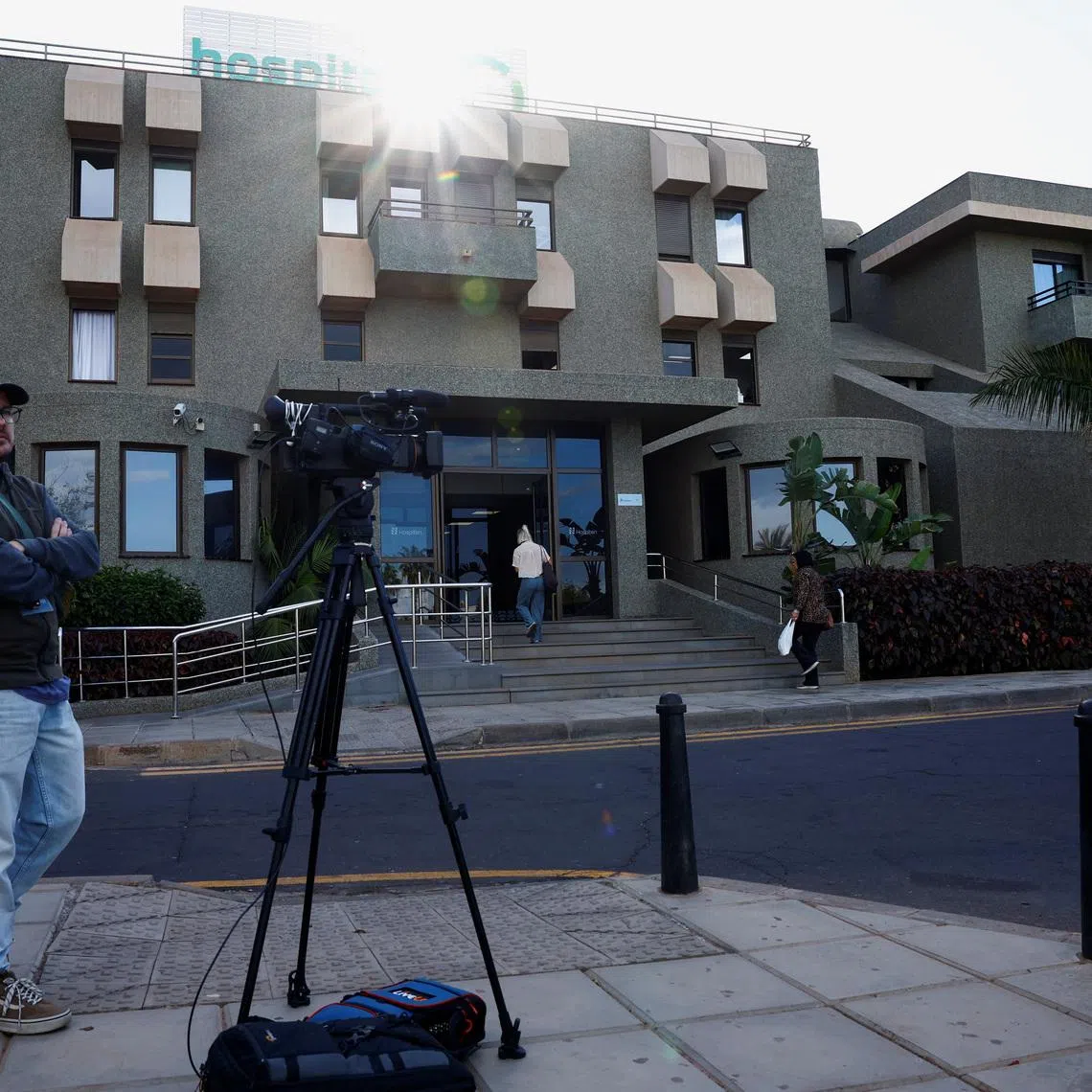 A member of the media works outside the hospital where Norway's King Harald was taken on Tuesday after suffering from an infection and dehydration, according to the royal palace, in Arona, Tenerife island, Spain, February 26, 2026. REUTERS/Borja Suarez