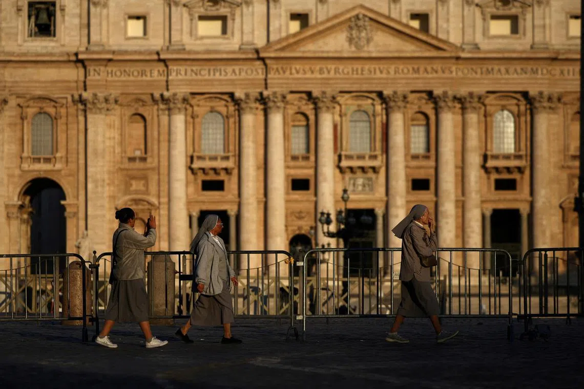 Nuns walk near St. Peter's Basilica at St. Peter's Square, ahead of the conclave to elect the next pope, as seen from Rome, Italy, May 4, 2025. REUTERS/Stoyan Nenov     TPX IMAGES OF THE DAY     