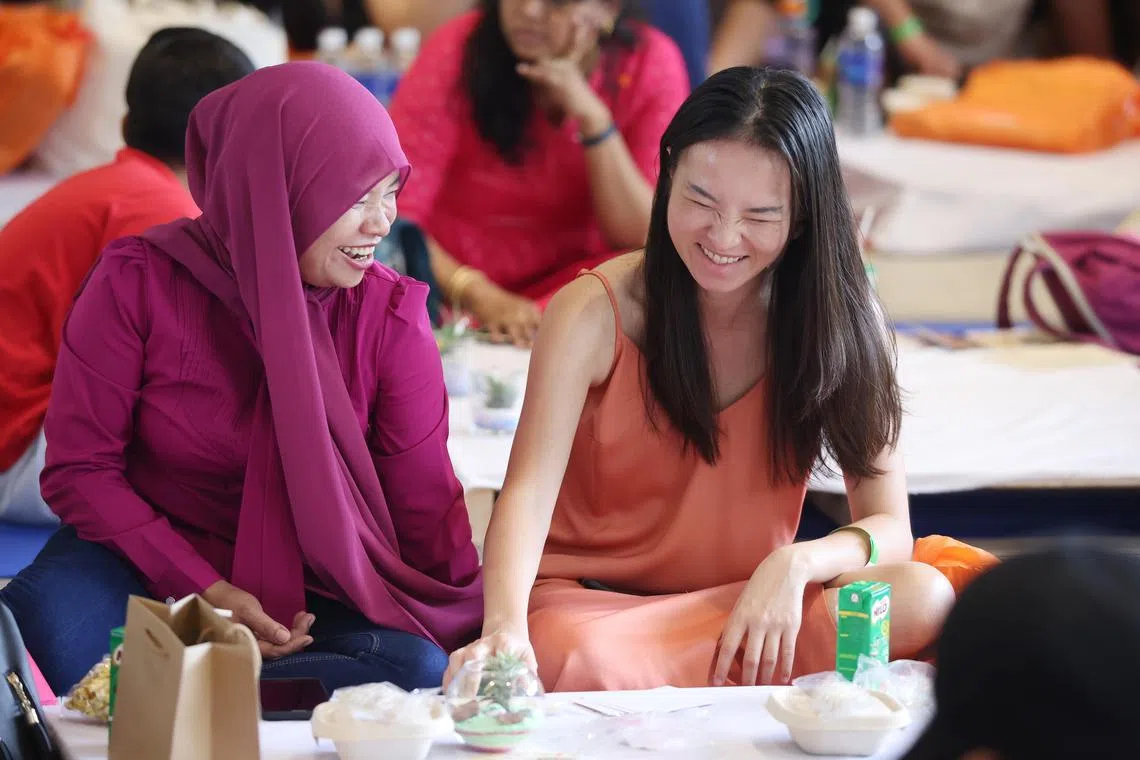 Employer Rebecca Yap (R), 31, sharing a moment with her domestic helper Suanah, 38. Their joint recipe Hakka Yam Satay Abacus Seed made it into the new online cookbook  called Flavours In Harmony.