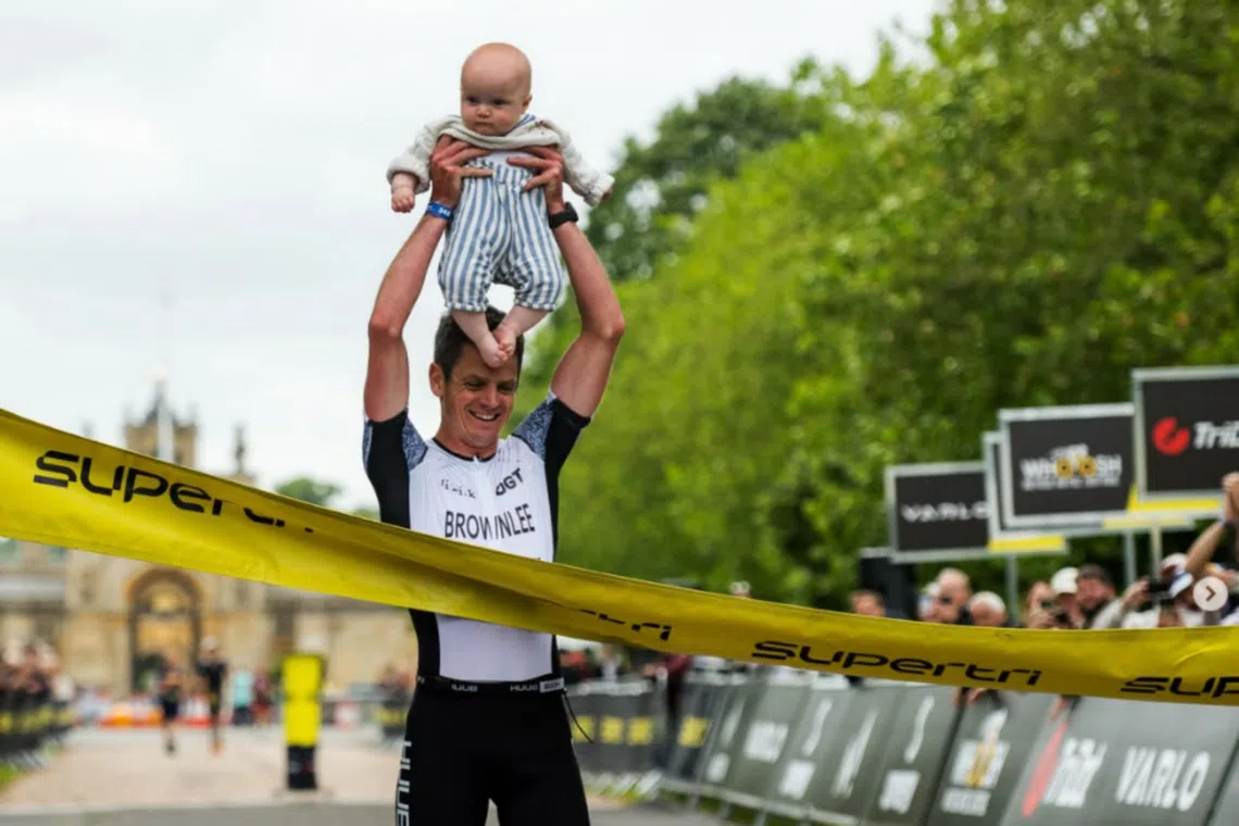Jonny Brownlee with his seven-month-old son Freddie at the Supertri Blenheim Palace event in June.