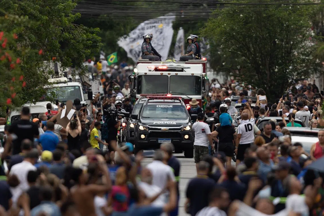 A fire truck carries the casket of late soccer legend Pele during his funeral procession through the streets of Santos, Brazil, Jan 3, 2023.