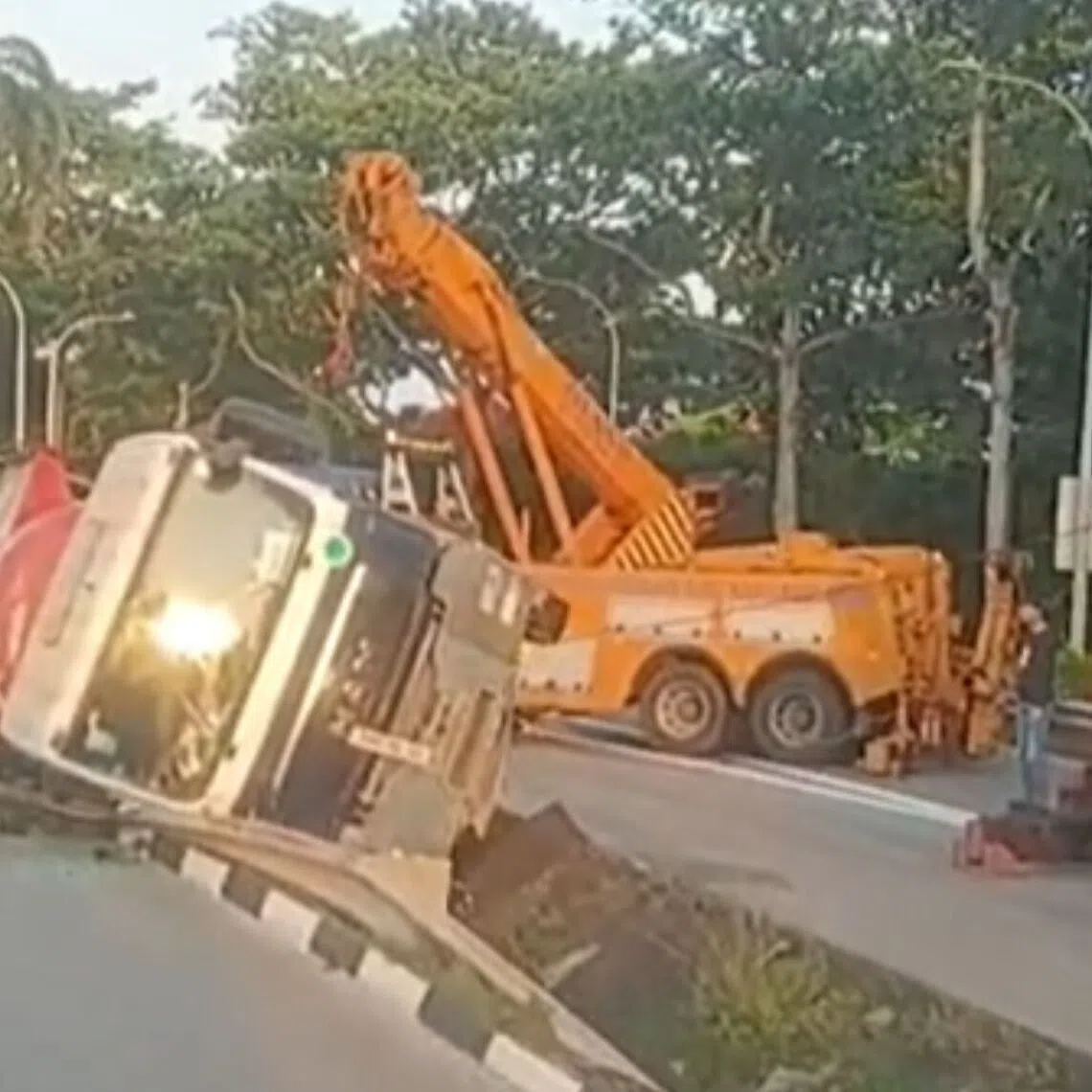 In a video of the aftermath of the accident, a tipper truck can be seen lying on its side in a drain which acts as a divider along the slip road.