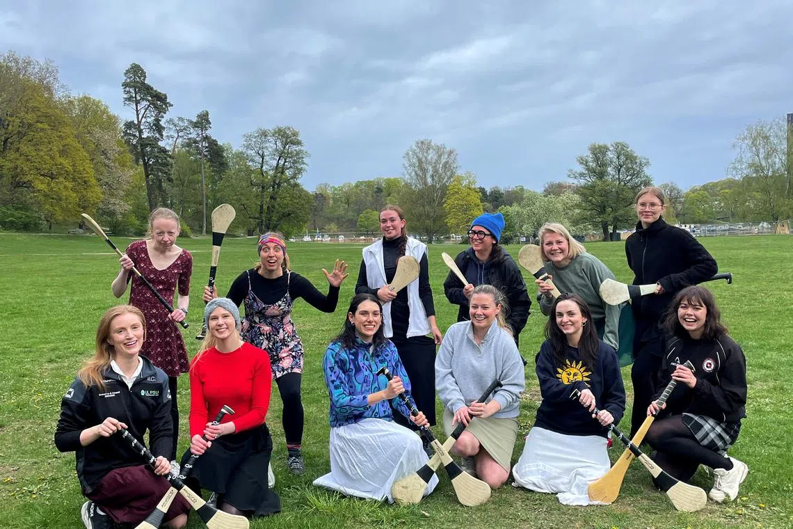 Camogie - Stockholm Gaels players pose with hurling sitcks - Stockholm, Sweden, May 10, 2025 Stockholm Gaels players pose with their \"caman\" (hurling stick) in solidarity with the Ireland Camogie players after the ban on the use of shorts for women REUTERS/Michelle Cotter