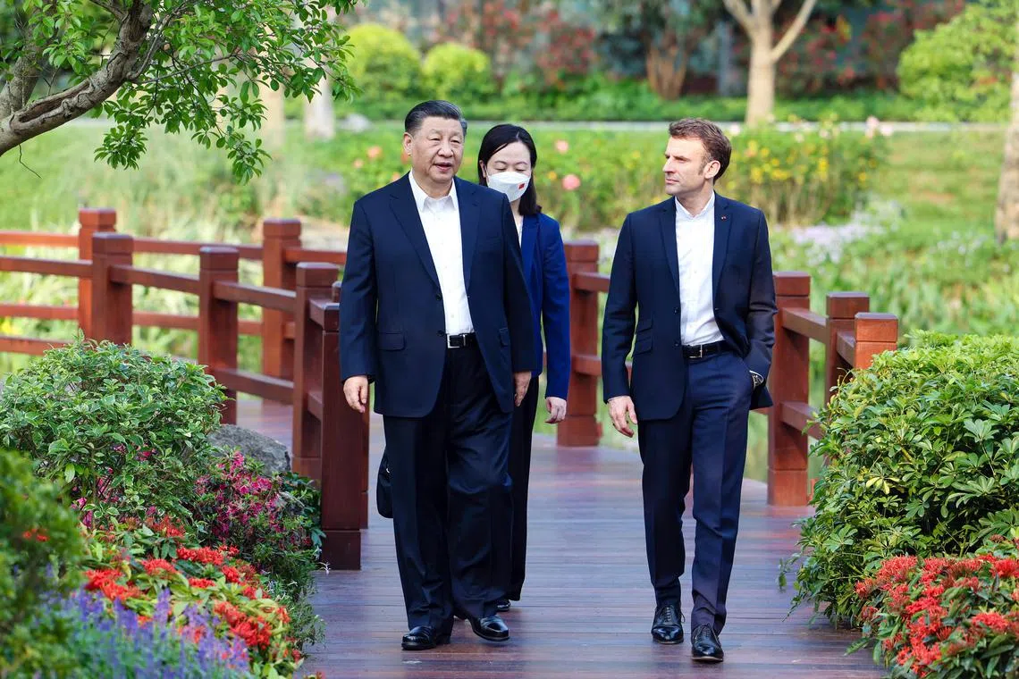 epa10564465 Chinese President Xi Jinping (L) and French President Emmanuel Macron (R) chat during a stroll through the Pine Garden in Guangzhou, Guangdong Province, China, 07 April 2023 (issued 08 April 2023).  EPA-EFE/XINHUA / Liu Bin CHINA OUT / MANDATORY CREDIT  EDITORIAL USE ONLY  EDITORIAL USE ONLY