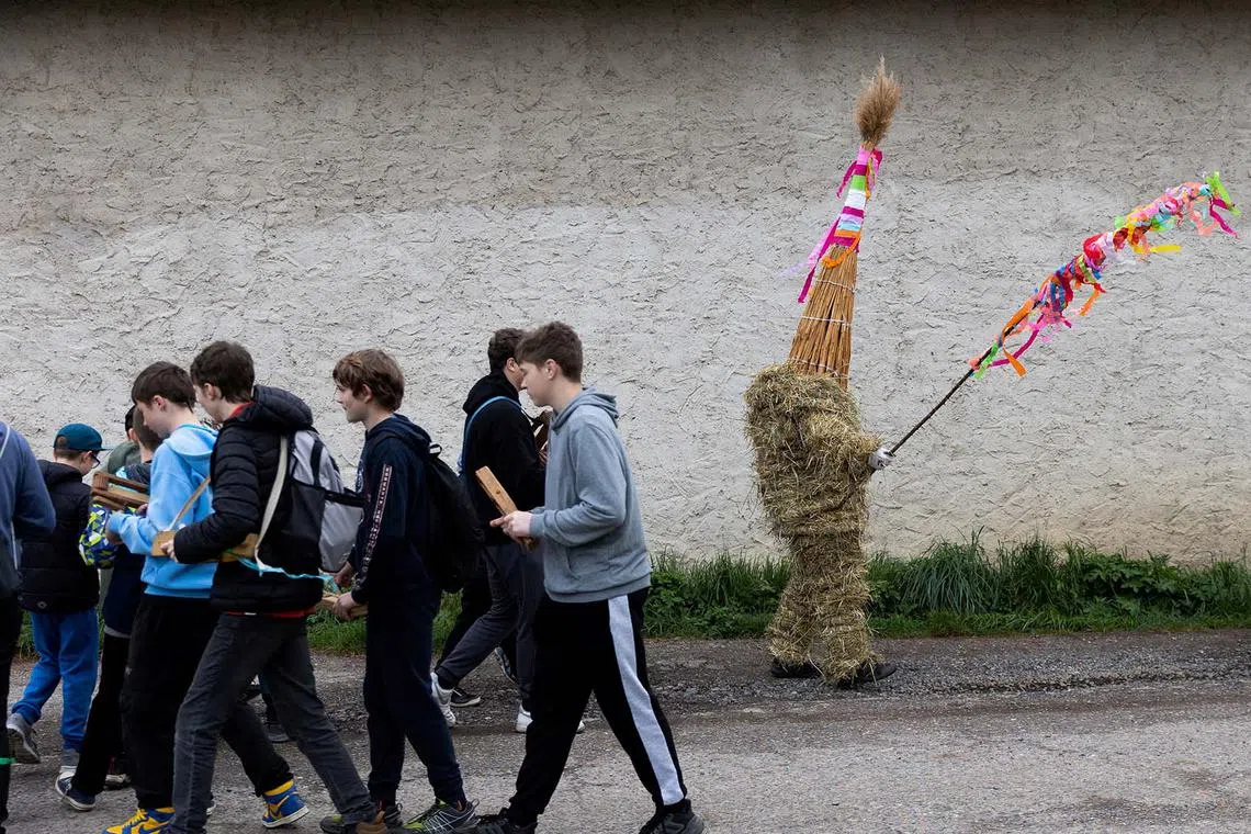 A boy dressed in a hay suit walking through the village as a part of an Easter celebration called Marching Judas, on Holy Saturday, in the village of Stradoun near Vysoke Myto, Czech Republic, April 19, 2025. 