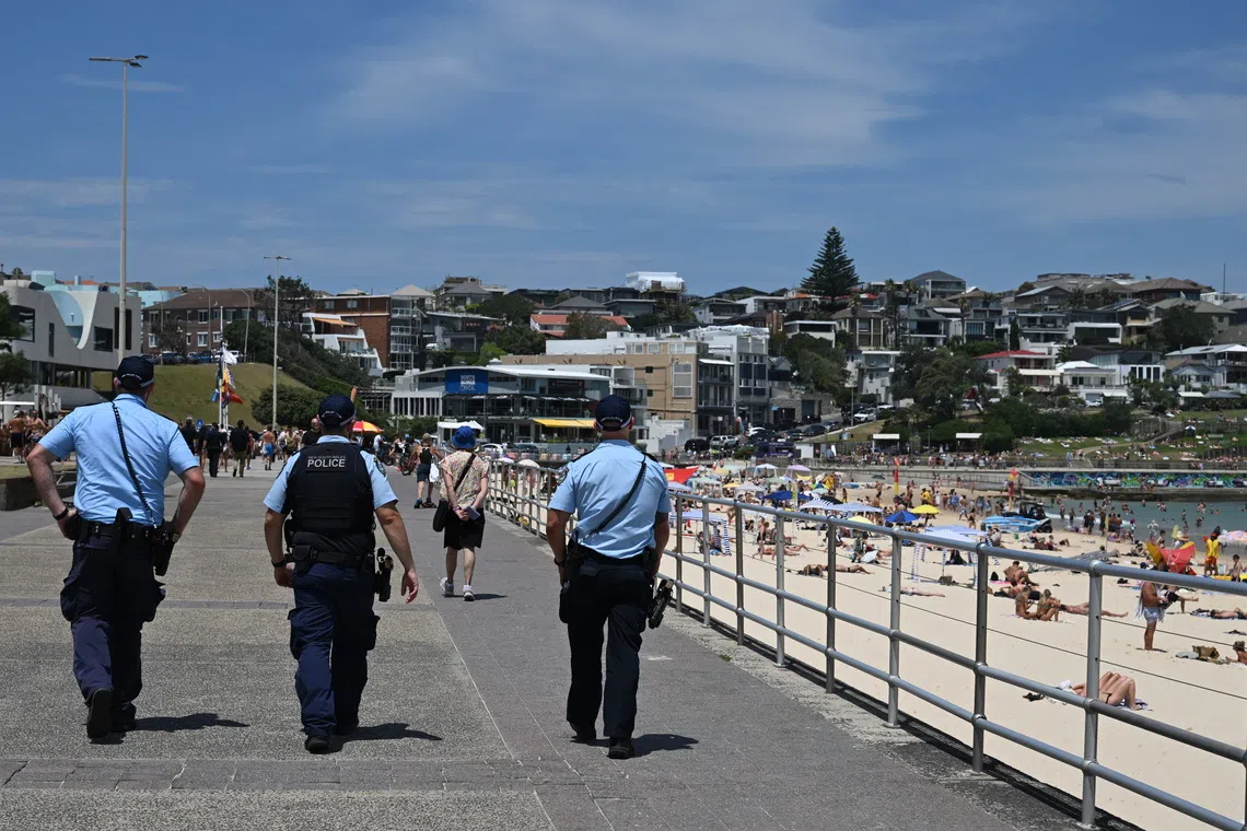 A heavy police presence as crowds return to Bondi Beach, one week on from a massacre at Sydney's most famous beach, on Dec 21.