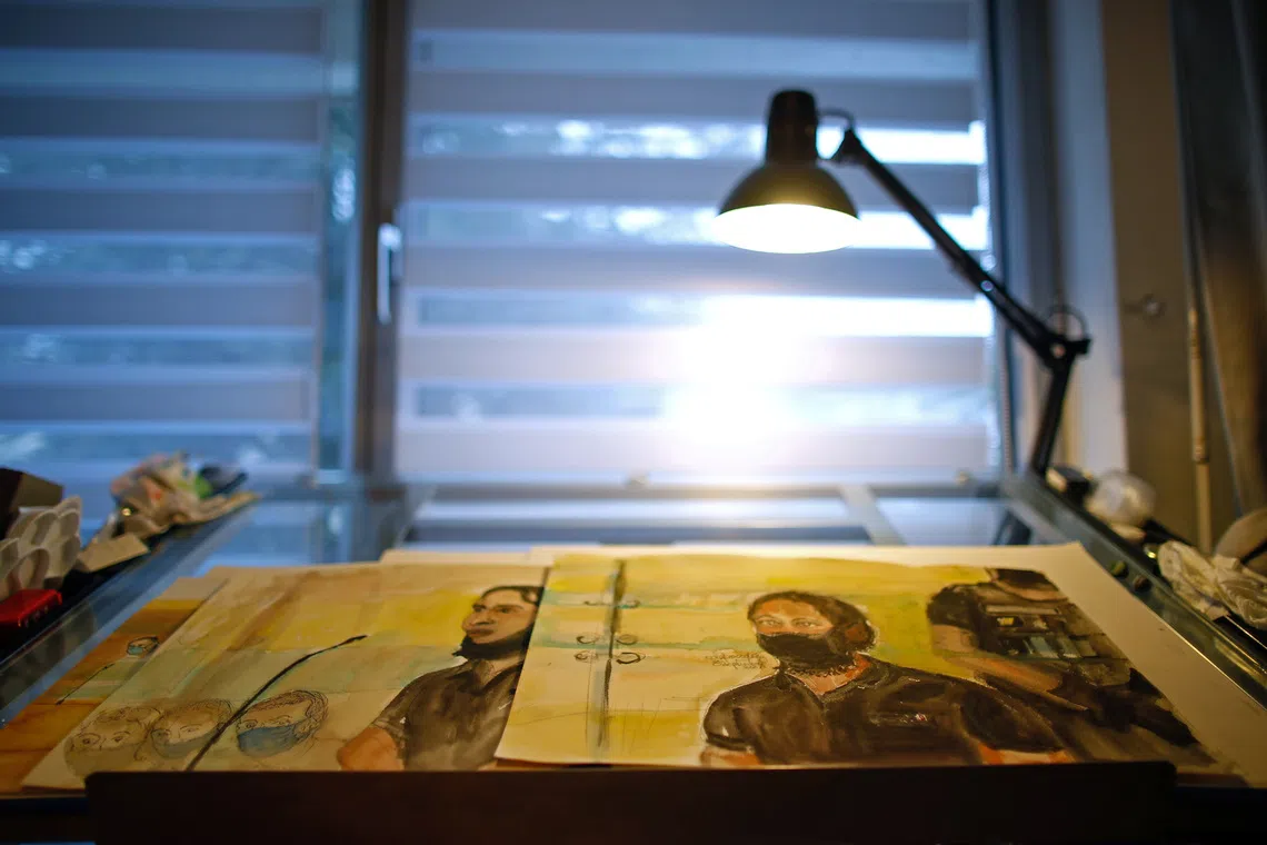 French court artist Elisabeth de Pourquery's sketches showing Salah Abdeslam, one of the accused, who is widely-believed to be the only surviving member of the group suspected of carrying out the Paris' November 2015 attacks, are displayed on a desk during an interview with Reuters at her home near Paris, France, September 27, 2021. Picture taken September 27, 2021. REUTERS/Gonzalo Fuentes