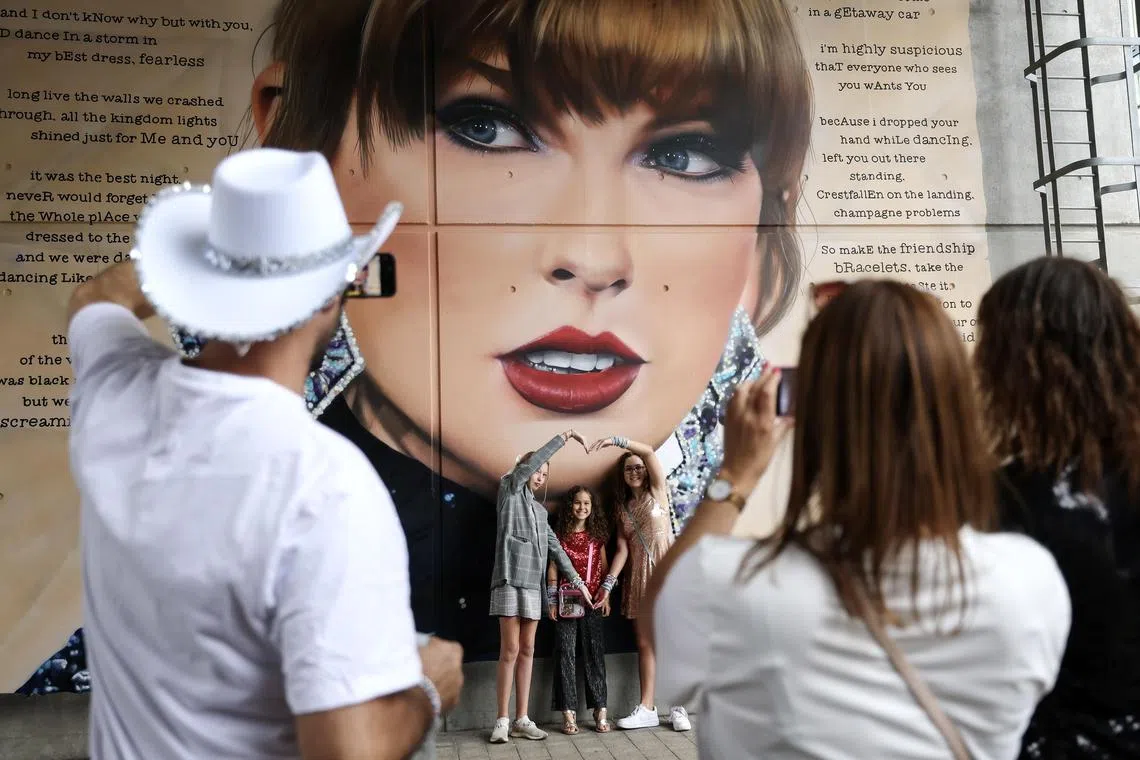 epa11550231 Taylor Swift fans pose for photographs in front of a mural outside Wembley Stadium before the first of the current Eras Tour series of concerts at Wembley Stadium, in London, Britain, 15 August 2024. The last concerts of US pop star's Eras Tour in Europe take place at London's Wembley Stadium from 15 to 20 August 2024. The concerts will go ahead amid additional security measures following the cancellation of Swift's three shows in Vienna earlier in August 2024. London Metropolitan Police's spokesperson had said that 'There is nothing to indicate that the matters being investigated by the Austrian authorities will have an impact on upcoming events here in London.'  EPA-EFE/ANDY RAIN
