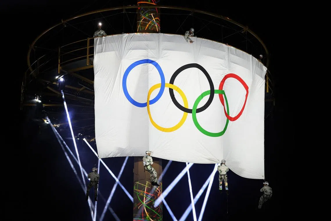 Winter Olympics - Olympic flag arrives in France - Albertville, France - February 23, 2026 Military personnel display the Olympic flag during the event. REUTERS/Pierre Albouy