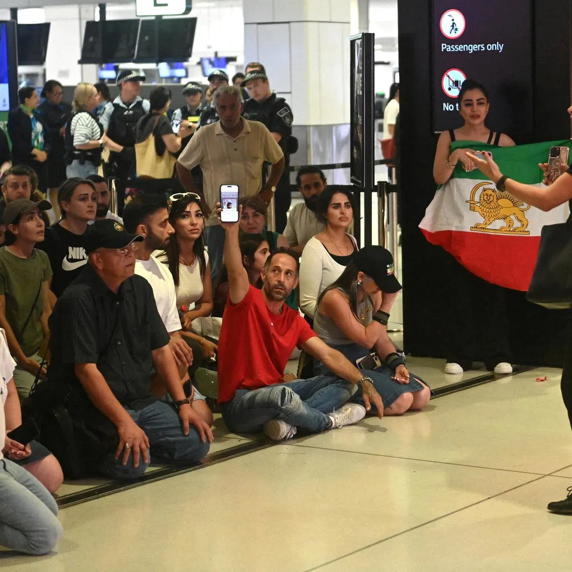 Supporters of the Iranian women's soccer team gather at Sydney Airport, after five of the players were granted asylum, in Sydney, Australia, March 10, 2026. REUTERS/Jeremy Piper