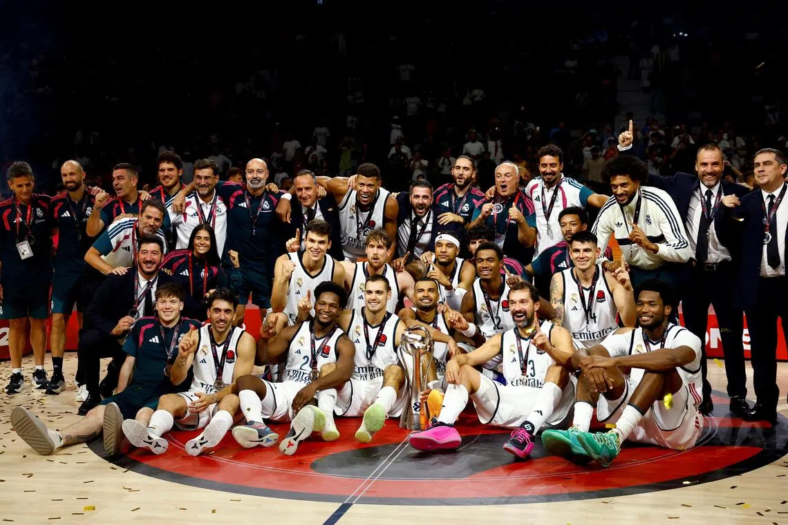 Real Madrid players and staff celebrate with the trophy after winning the Euroleague Basketball SuperCup at the Etihad Arena in Abu Dhabi on Sept 19.
