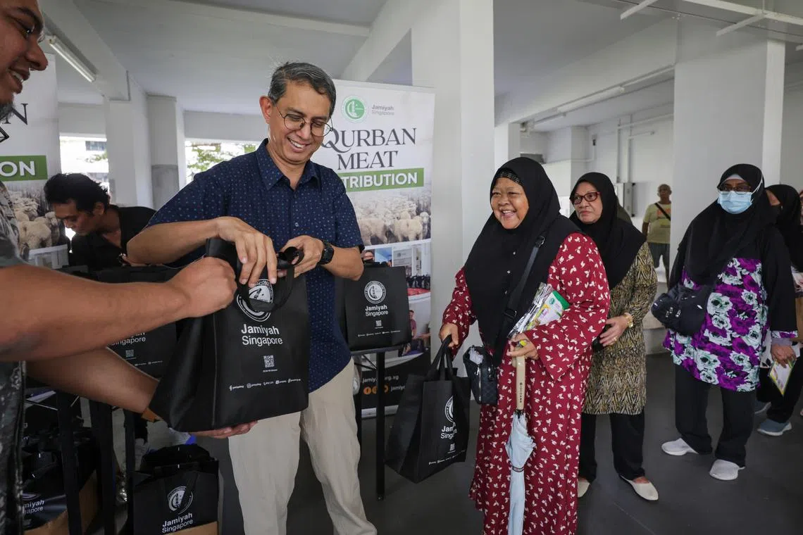 Acting Minister-in-Charge of Muslim Affairs Faishal Ibrahim distributing korban meat to low income residents on July 13.