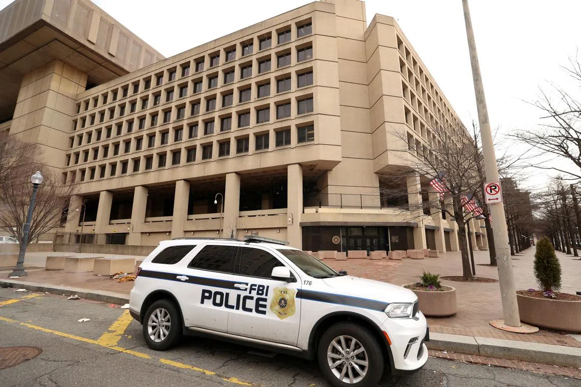 An FBI police car stands outside FBI headquarters in Washington on Feb 3, days after the Trump administration launched a sweeping round of cuts at the Justice Department. 
