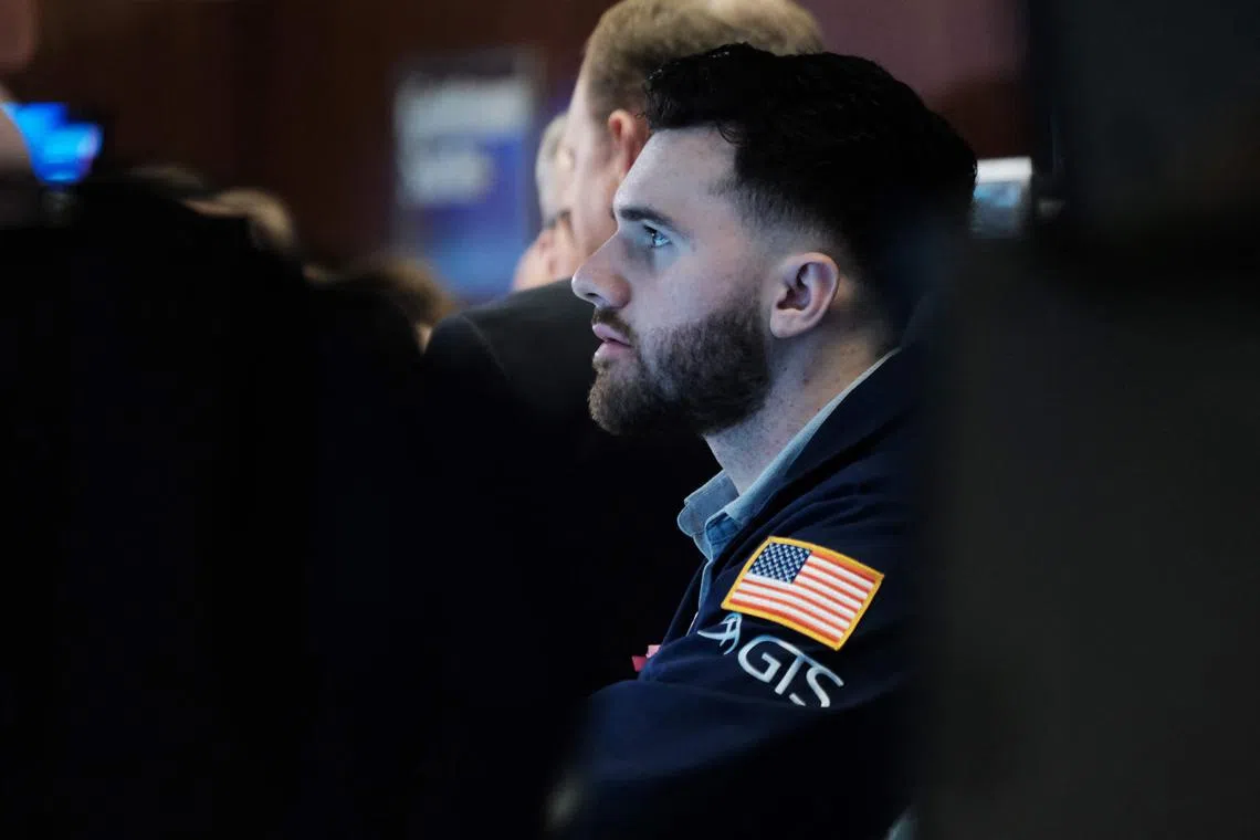 Traders work on the floor of the New York Stock Exchange, in New York City.